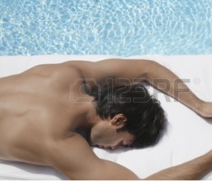23031424-young-man-with-book-sleeping-by-pool